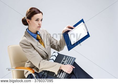Filmmaking Concepts. Portrait Of Confident Professional Female Film Director Posing With Actioncut. 