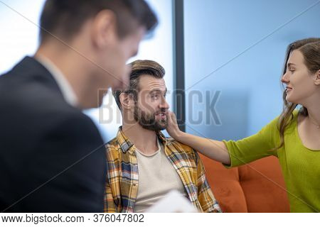Young And Cheerful Woman Touching Her Husbands Beard
