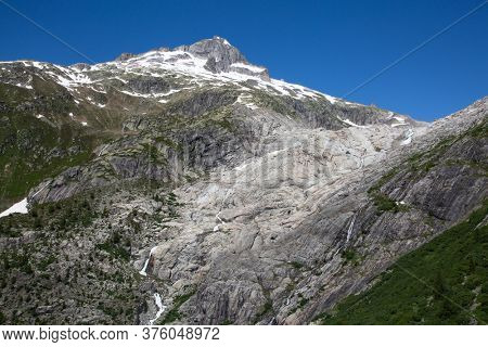 Rhone glacier, source of Rhone river, melting and retreating due to global warming. Rhone glacier is loosing up to 2 meters in length every year.