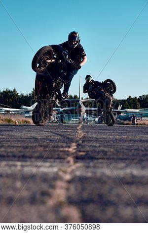 Moscow, Russia - 12 Jul 2020: Moto rider making a stunt on his motorbike. Stunt motorcycle rider per