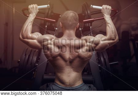 Bodybuilder Strong Man Pumping Up Biceps Muscles.