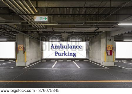 Parking Garage Underground Interior With Ambulance Reserved Parking Apaces Sign Board