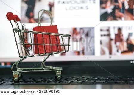 Shopping Online, E-commerce Concept:  Paper Shopping Bags On Notebook Keyboard. Depicts Purchase Of 