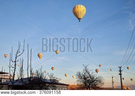 Cappadocia, Turkey - December 20, 2019: Hot Air Balloons Flying In Blue Sky With White Clouds Over H