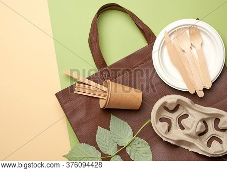 Disposable Paper Utensils From Brown Craft Paper And Recycled Materials On A Green Background, Plast