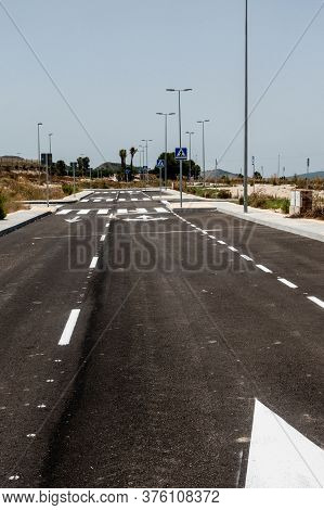 New Road Markings And Road Signs On Freshly Tarmacked Roads On Spanish Urbanisation