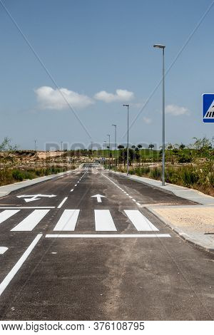 New Road Markings And Road Signs On Freshly Tarmacked Roads On Spanish Urbanisation