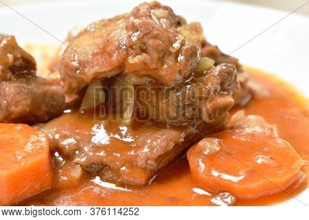 Fried Pork Bone With Slice Carrot And Onion With Swet And Sour Sauce On Plate