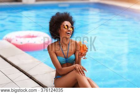 Tropical Summer Vacation. Sensual African American Lady Enjoying Her Cocktail Drink Near Outdoor Poo