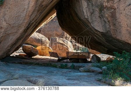 Two Benches Underneath Large Boulders At Bulls Party At Ameib In The Erongo Region Of Namibia
