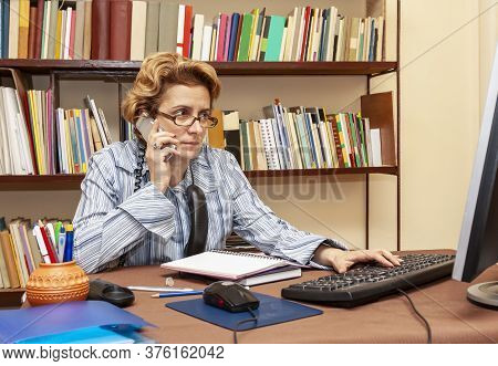 Image Of A Busy Woman Teleworking At Her Desk At The Home. Working At Home Became An Important Recom