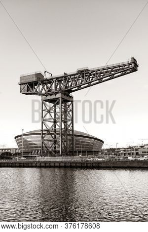 GLASGOW, UK - FEB 26, 2020: The Finnieston Crane or Stobcross Crane stand at waterfront of city center in Scotland, United Kingdom as the symbol of engineering heritage