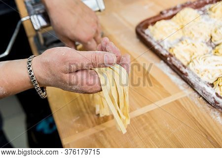 Chef Rolling Dough With A Pasta Machine. Pasta Maker Machine. Hom