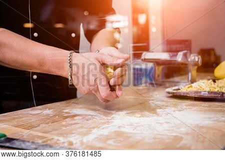 Chef Rolling Dough With A Pasta Machine. Pasta Maker Machine. Hom