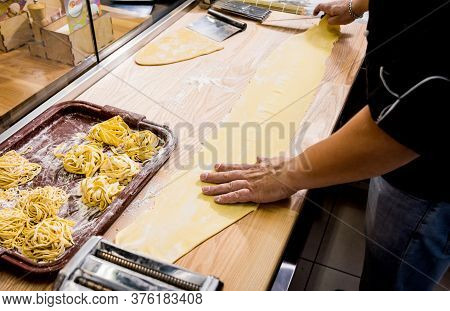 Chef Rolling Dough With A Pasta Machine. Pasta Maker Machine. Hom