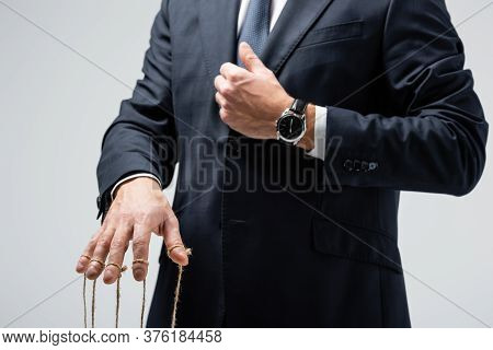 Cropped View Of Puppeteer In Suit With Strings On Fingers Isolated On Grey