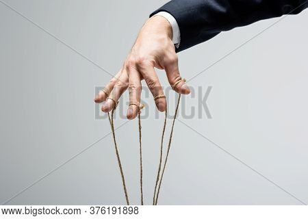 Cropped View Of Puppeteer With Strings On Fingers Isolated On Grey