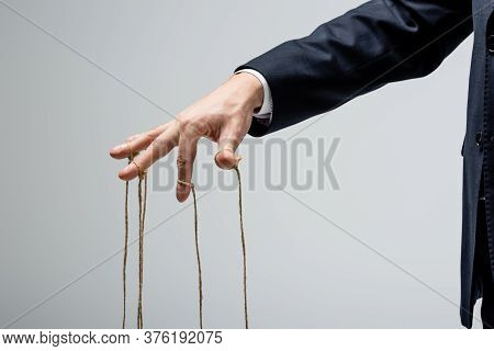 Cropped View Of Puppeteer With Strings On Fingers Isolated On Grey