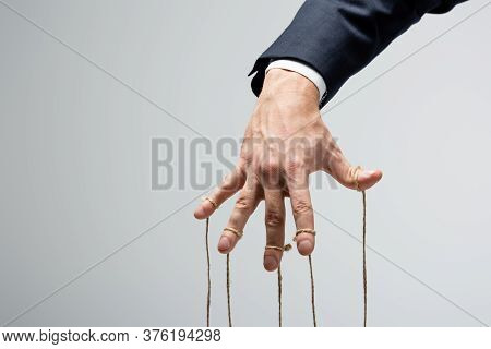 Cropped View Of Puppeteer With Strings On Fingers Isolated On Grey