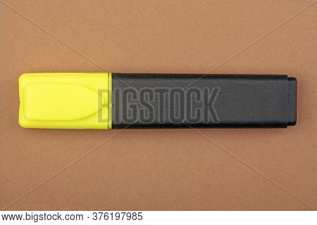 Yellow Textmarker On Brown Background. Shot In Studio.