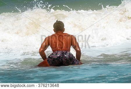 Young Handsome Man Wet All Over Body Holding Surfboard With Right Hand,walking On The Beach,show Fit