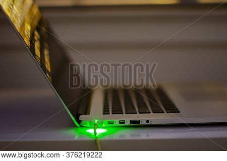 Calgary, Alberta. Canada. July 14, 2020. Macbook Computer Charging During The Night Side View Magsaf