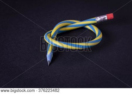 Flexible Pencil On A Dark Background. Selective Focus