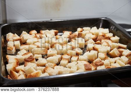 Square Toasted Pieces Of Homemade Delicious Rusk, Hardtack, Dryasdust, Zwieback On A Baking Sheet.