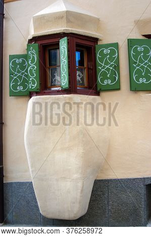 Small Balcony With Wooden Windows And Green Shutters In The Ancient Village Of Guarda, Scuol Municip