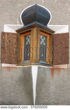 Old And Small Balcony With Wooden Windows In The Ancient Village Of Zuoz, Tourist Resort In Engadin 
