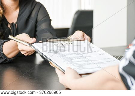 Employer Or Boss Is Interviewing For Jobs And Positions. Woman Sitting Smiling While Submitting A Re