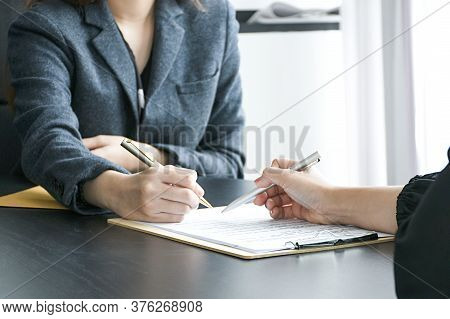 Employer or boss is interviewing for jobs and positions. Woman sitting smiling while submitting a re