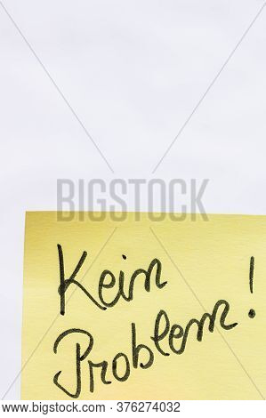 Kein Problem (no Problem)  Handwriting Text Close Up Isolated On Yellow Paper With Copy Space.