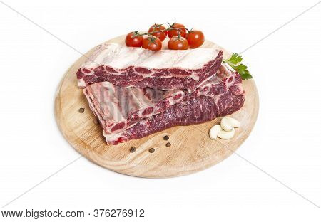 Raw Beef Ribs On A Cutting Board Isolated On A White Background