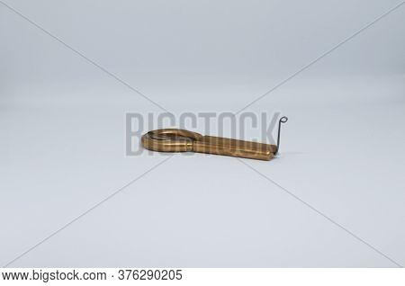 Macrophotography Of An Old Jaw Harp - Isolated On White Background