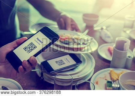 Hand Using Smart Phone To Scan Qr Code On Tag With Blurry Many Dishes After Eating In Restaurant To