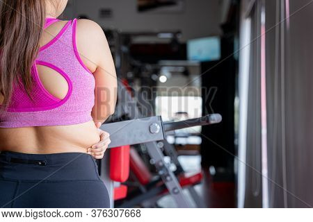 Fat Woman Holding Excessive Fat Belly Lower Back, Overweight Fatty Belly At Fitness Gym. Diet Lifest