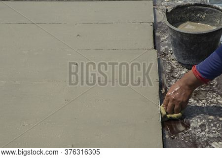 Cement Surface Adjusting With Hand Of Worker And Waiting For Cure By Sunligth In Out Door In Hands H
