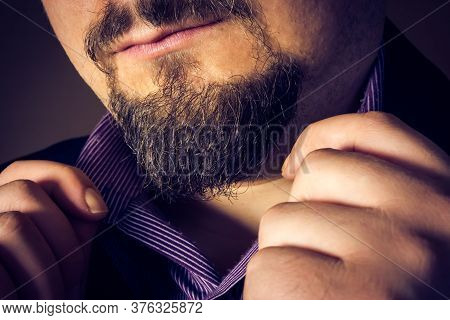 Elegant Man Holding His Purple Shirt Collars