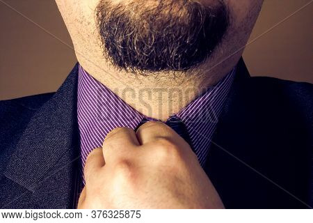 Elegant Dressed Man Doing His Shirt Button