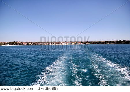Turbulence Made By Foam Of Sea Water From A High-speed Yacht On Surface Of Sea. Blue Sea Waves With 