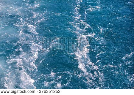Turbulence Made By Foam Of Sea Water From A High-speed Yacht On Surface Of Sea. Blue Sea Waves With 