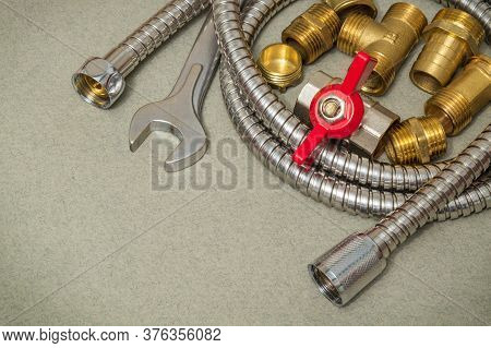 Plumbing Materials Faucet, Tool, Fittings And Hose On A Dark Green Background Are Used For Replaceme