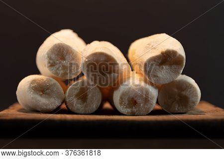 Edible Manioc Root (manihot Esculenta), Peeled And Frozen On Neutral Background