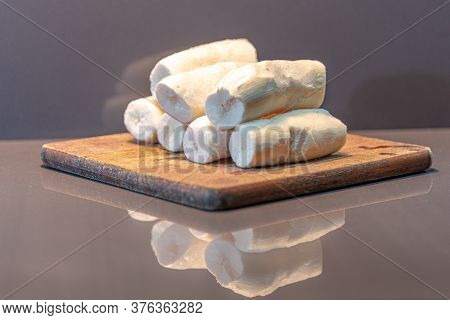 Edible Manioc Root (manihot Esculenta), Peeled And Frozen On Neutral Background