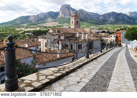 Street To The Village And Church Of Polop De Marina With Rocky Mountainrange, Costa Blanca, Spain