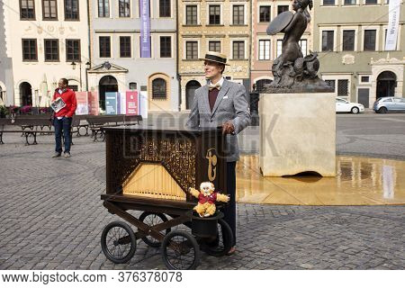 Polish People Wearing Retro Clothes Playing Antique Instrument Music Box Mobile For Show Travelers A