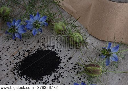 Black Cumin (nigella Sativa Or Kalonji) Seeds In Heart-shaped Bowl On Wooden Background