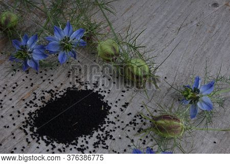 Black Cumin (nigella Sativa Or Kalonji) Seeds In Heart-shaped Bowl On Wooden Background