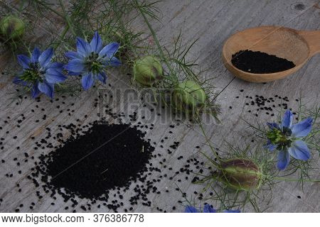 Black Cumin (nigella Sativa Or Kalonji) Seeds In Heart-shaped Bowl On Wooden Background